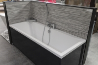 A square bath with a bath and shower mixer.